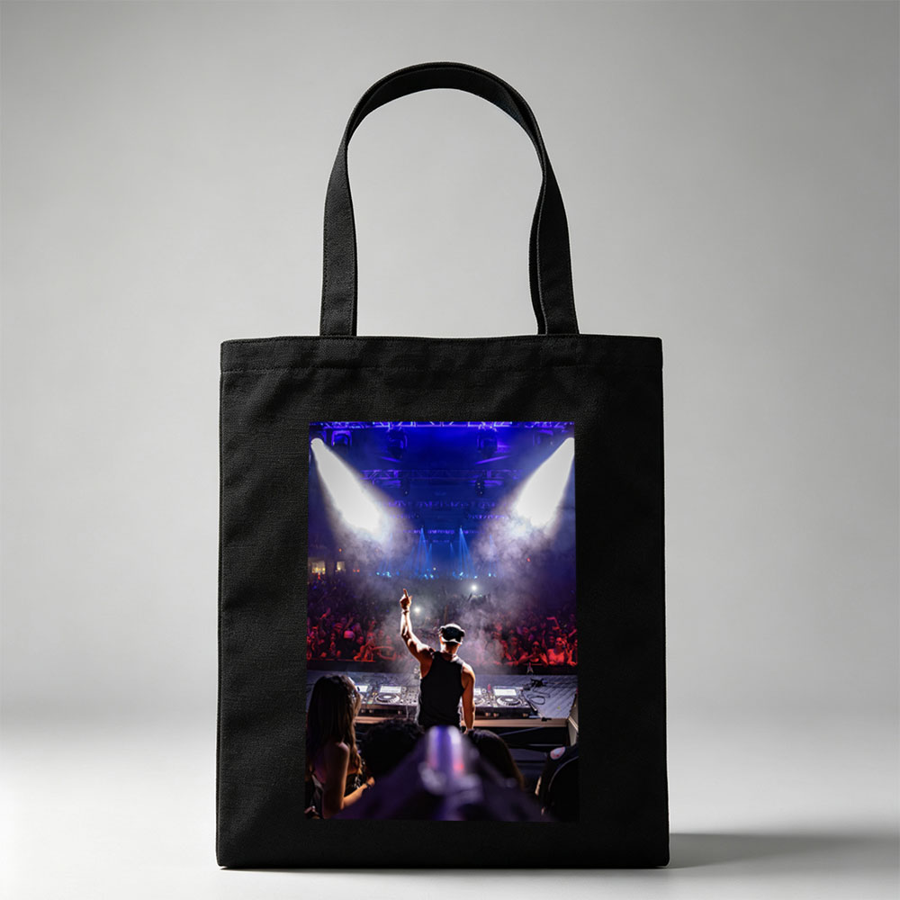 DJ Martin Garrix Performing at a High-Energy Concert with Crowd in the Background - Canvas tote bags