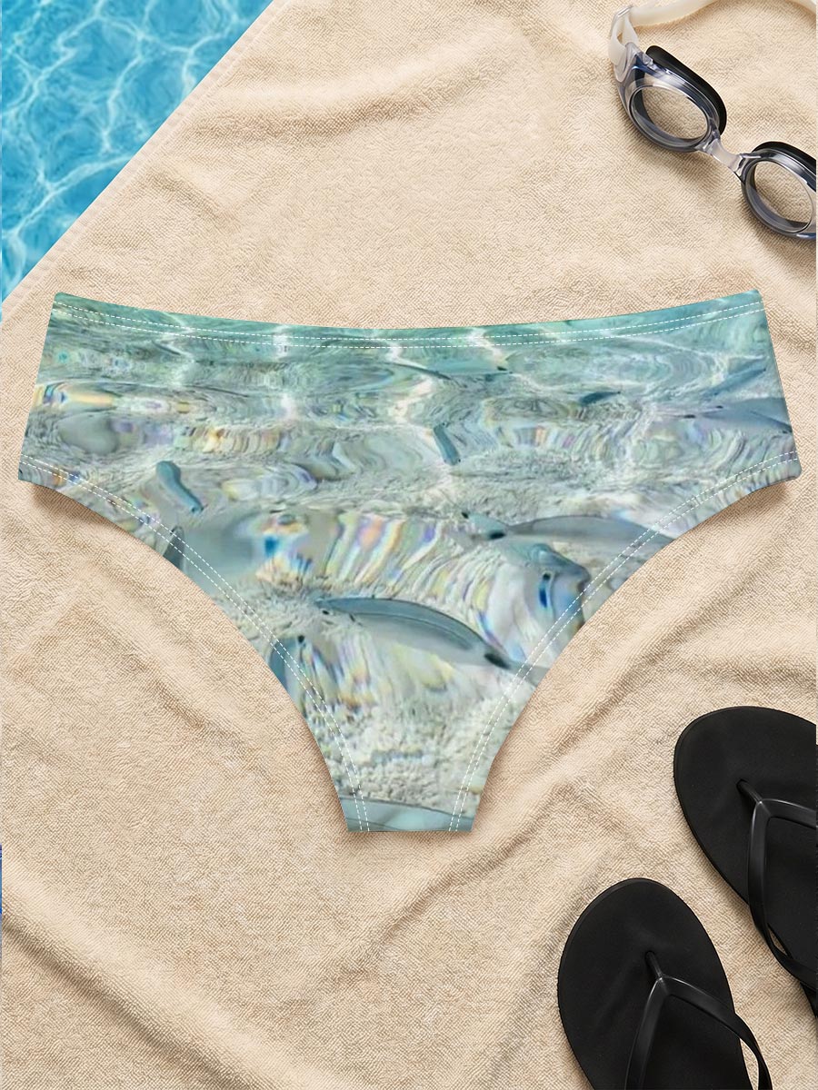Clear waters reveal schools of fish swimming near a rocky shore with boats in the distance. -  Men's swim trunks