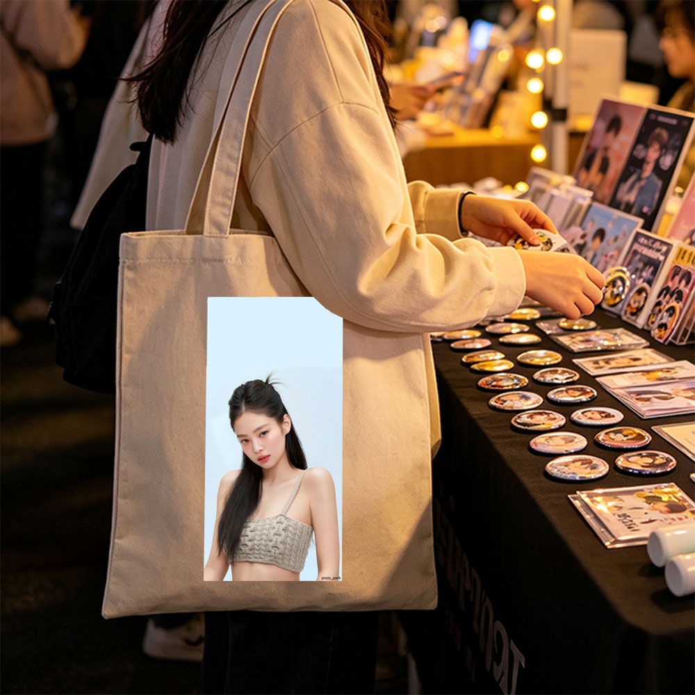 Jennie Kim in a Minimalist Look Wearing a Beige Knit Crop Top Against a Soft Blue Background - Canvas tote bags