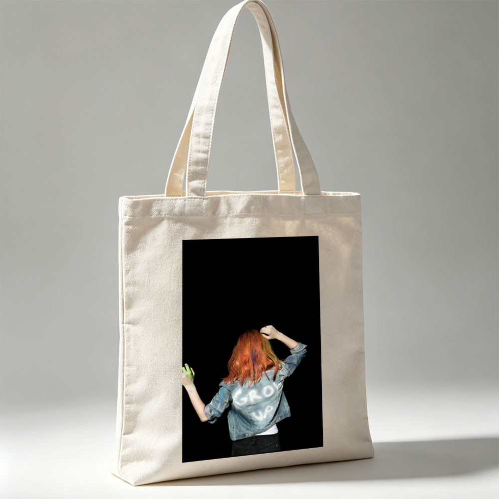 BTS Jungkook in a vibrant performance scene with colorful hair and denim jacket against a black background - Canvas tote bags