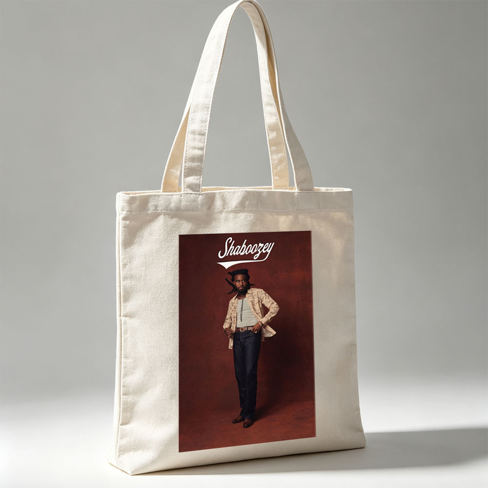 Shaboozey Standing Confidently in a Patterned Jacket and Jeans Against a Rich Red Background - Canvas tote bags