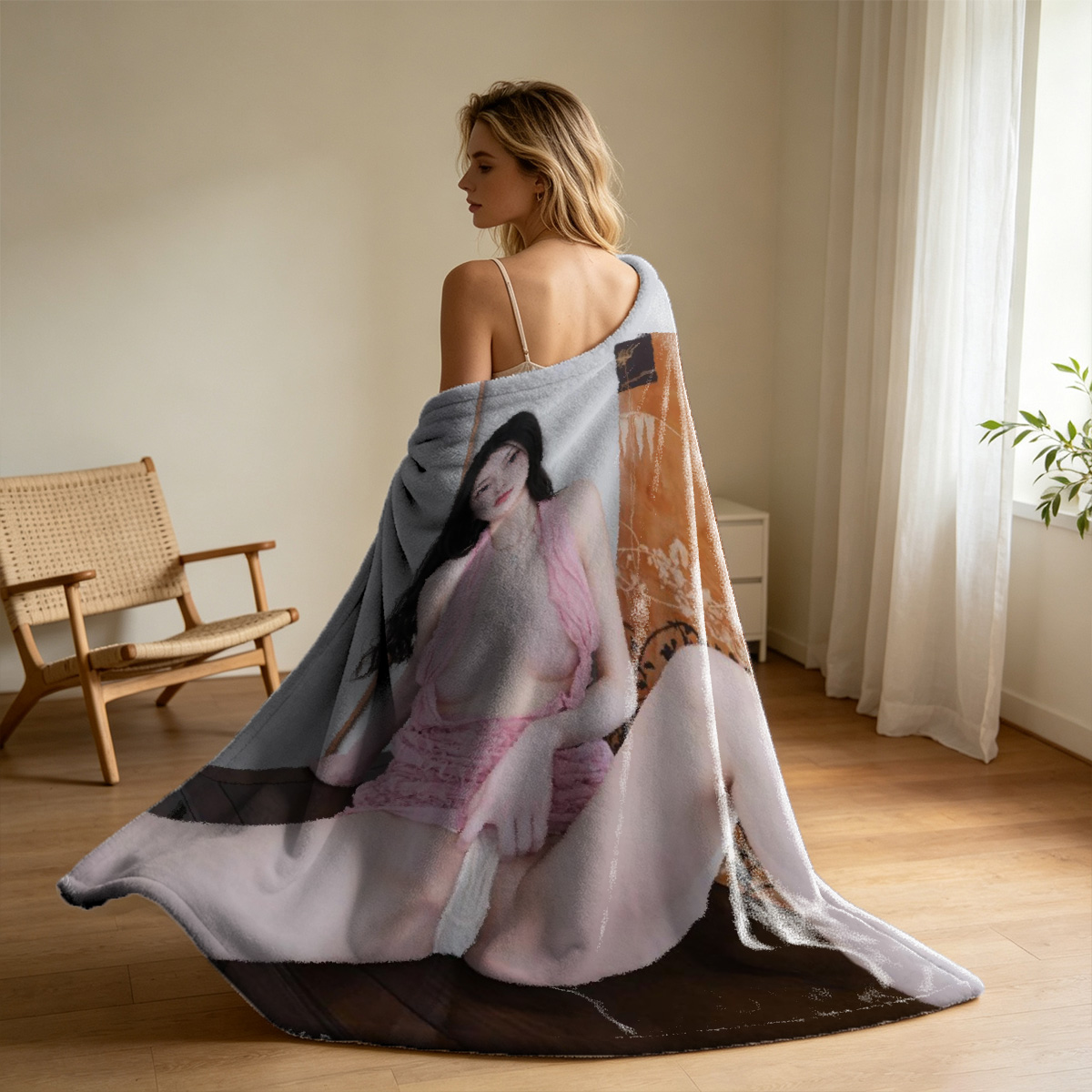 Elegant Asian beauty in sheer gray slip dress seated on leather couch by window. - Blanket