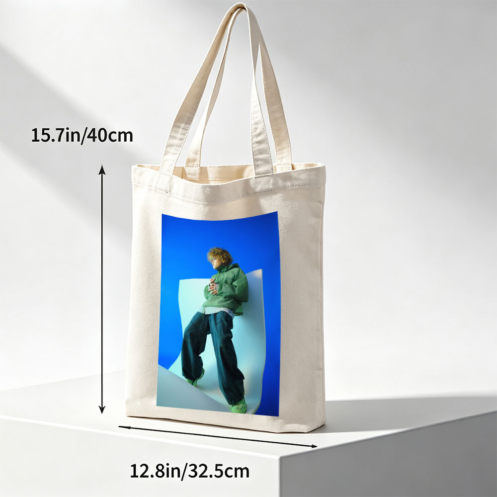 Jaden Smith in a Fashion Shoot Wearing Oversized Green Jacket and Baggy Jeans Against a Blue Background - Canvas tote bags
