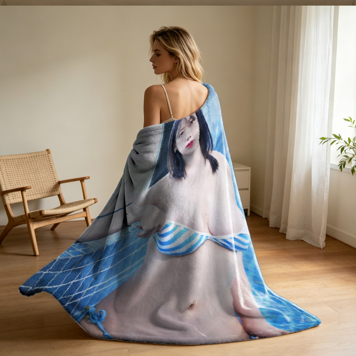 Emma Watson in a blue satin slip dress sitting barefoot on a leather couch. - Blanket