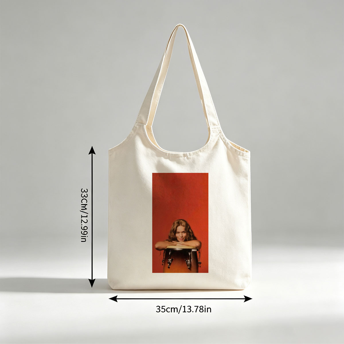 Rita Ora Leaning on a Drum Against a Red Background - Canvas shoulder bags/