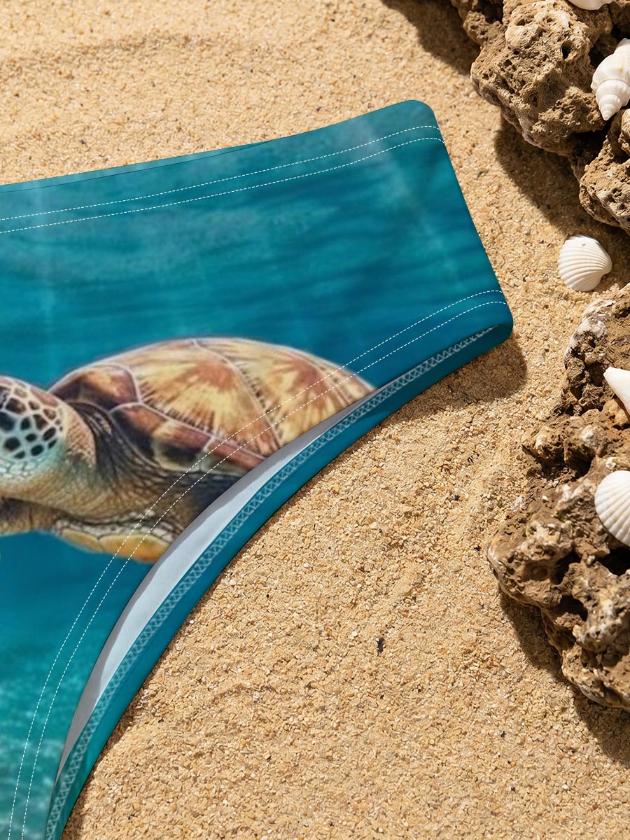 Sea turtle glides through sunlit waters, rays shimmering above. -  Men's swim trunks
