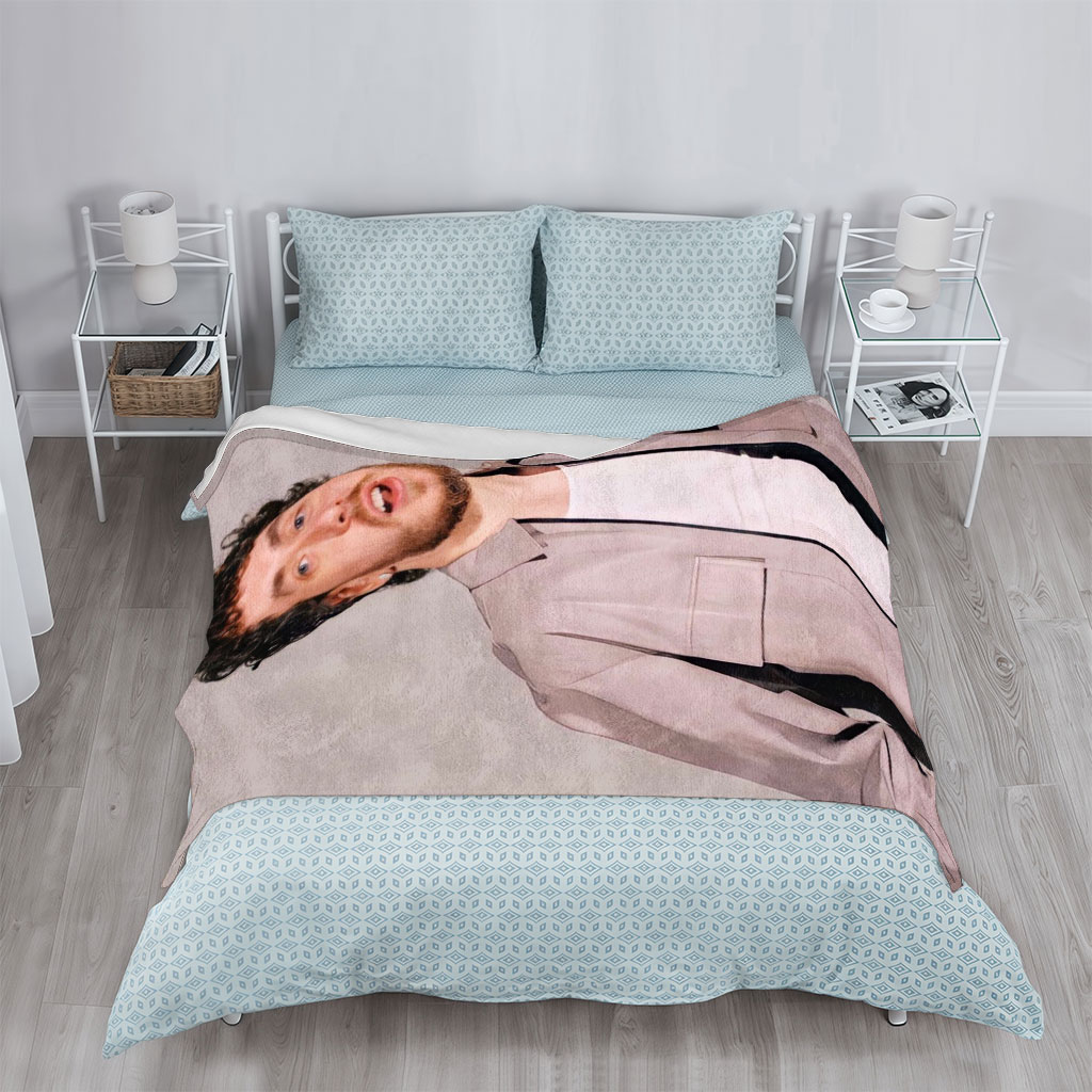 Jack Harlow in a Stylish Pose Wearing a Beige Jacket Over a White Shirt Against a Neutral Background - Blankets