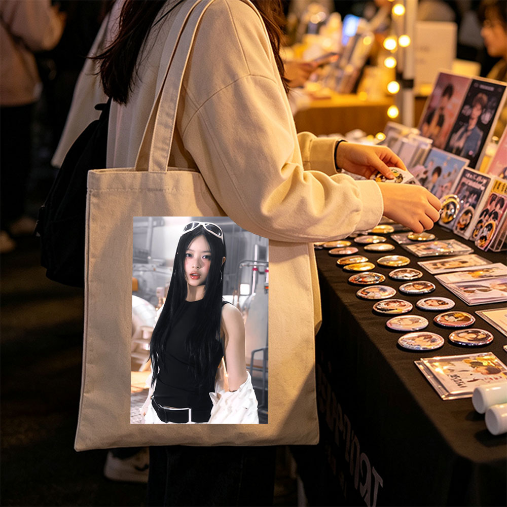 Hanni of NewJeans in a Futuristic Studio Setting Wearing a Black Top and White Ruffled Skirt with Sunglasses on Head - Canvas tote bags