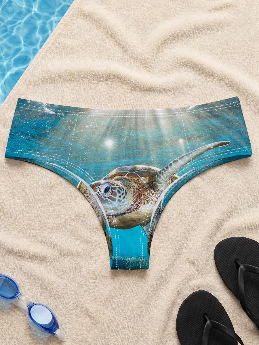 Sea turtle glides through sunlit coral reef -  Men's swim trunks