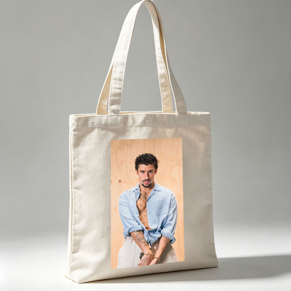 Bad Bunny in a Casual Pose Wearing an Open Light Blue Shirt and White Pants with Visible Tattoos - Canvas tote bags