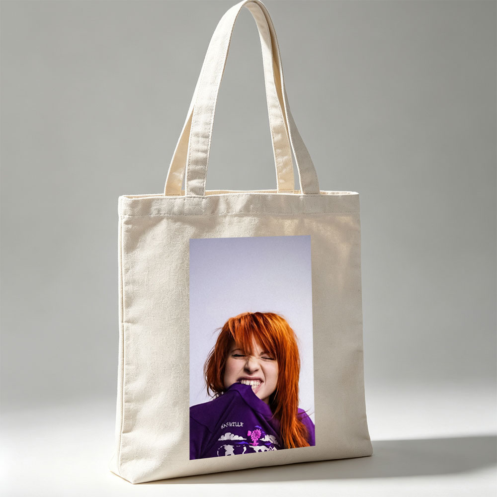 Hayley Williams from Paramore in a Playful Pose Wearing a Purple Nashville Shirt with a Vibrant Design - Canvas tote bags