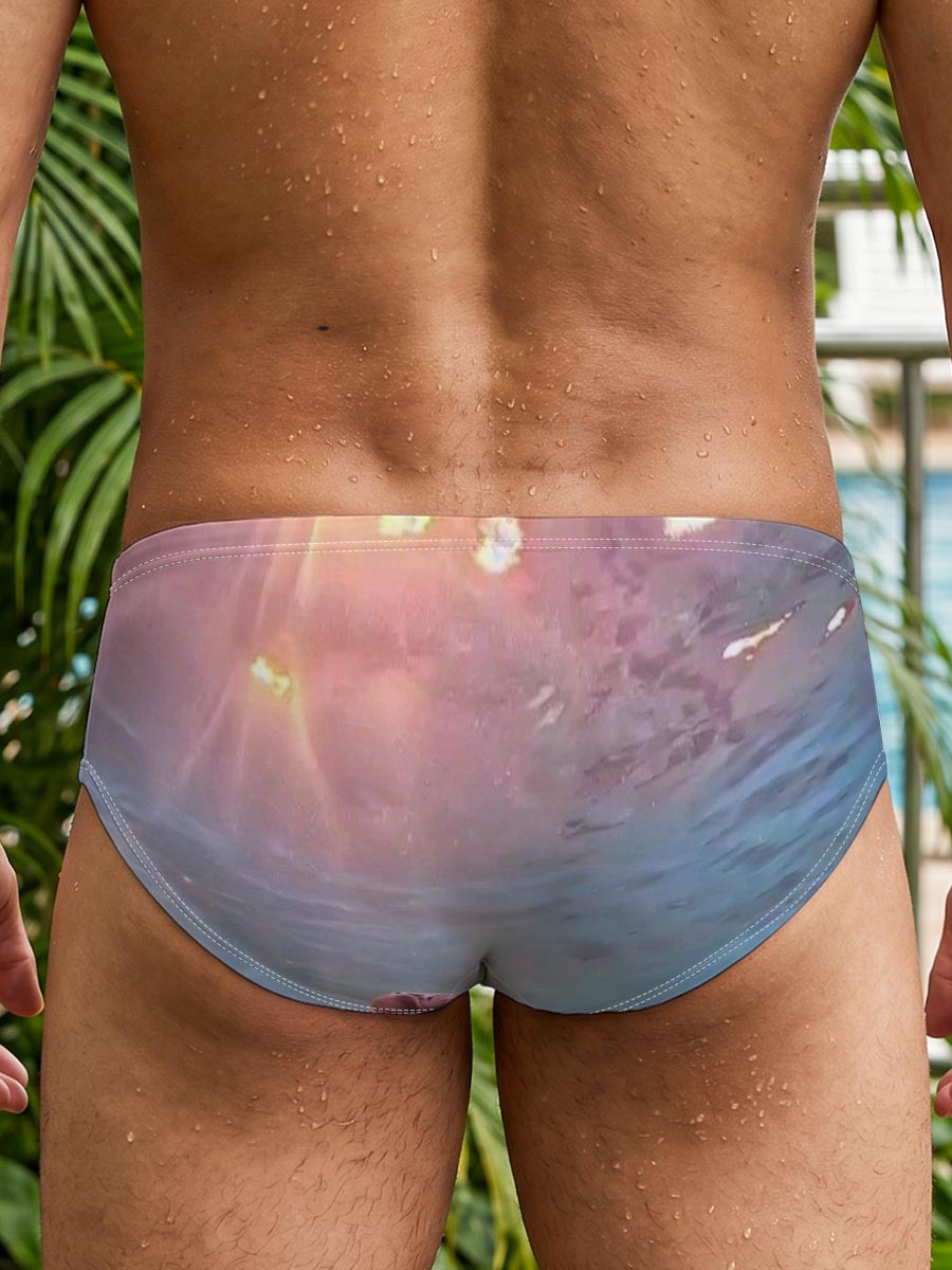 Sea turtle swims gracefully underwater as sunlight filters through the ocean surface. -  Men's swim trunks