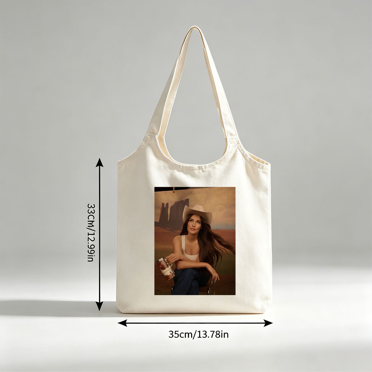 Jennifer Lopez in Cowboy Hat Holding a Mug Against Desert Backdrop - Canvas shoulder bags/