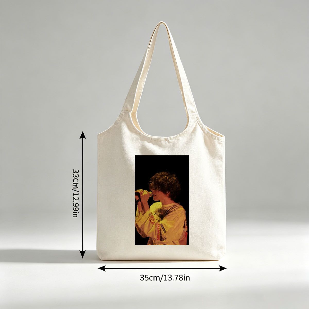 Harry Styles Singing on Stage in a Yellow Outfit with Microphone - Canvas shoulder bags/