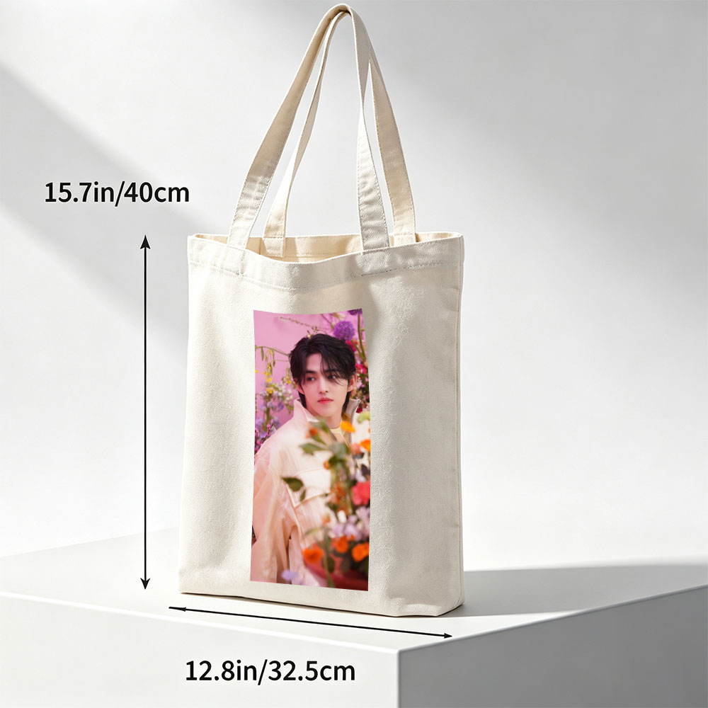 Sungchan in a floral garden, wearing a soft pink jacket with vibrant flowers in the foreground - Canvas tote bags