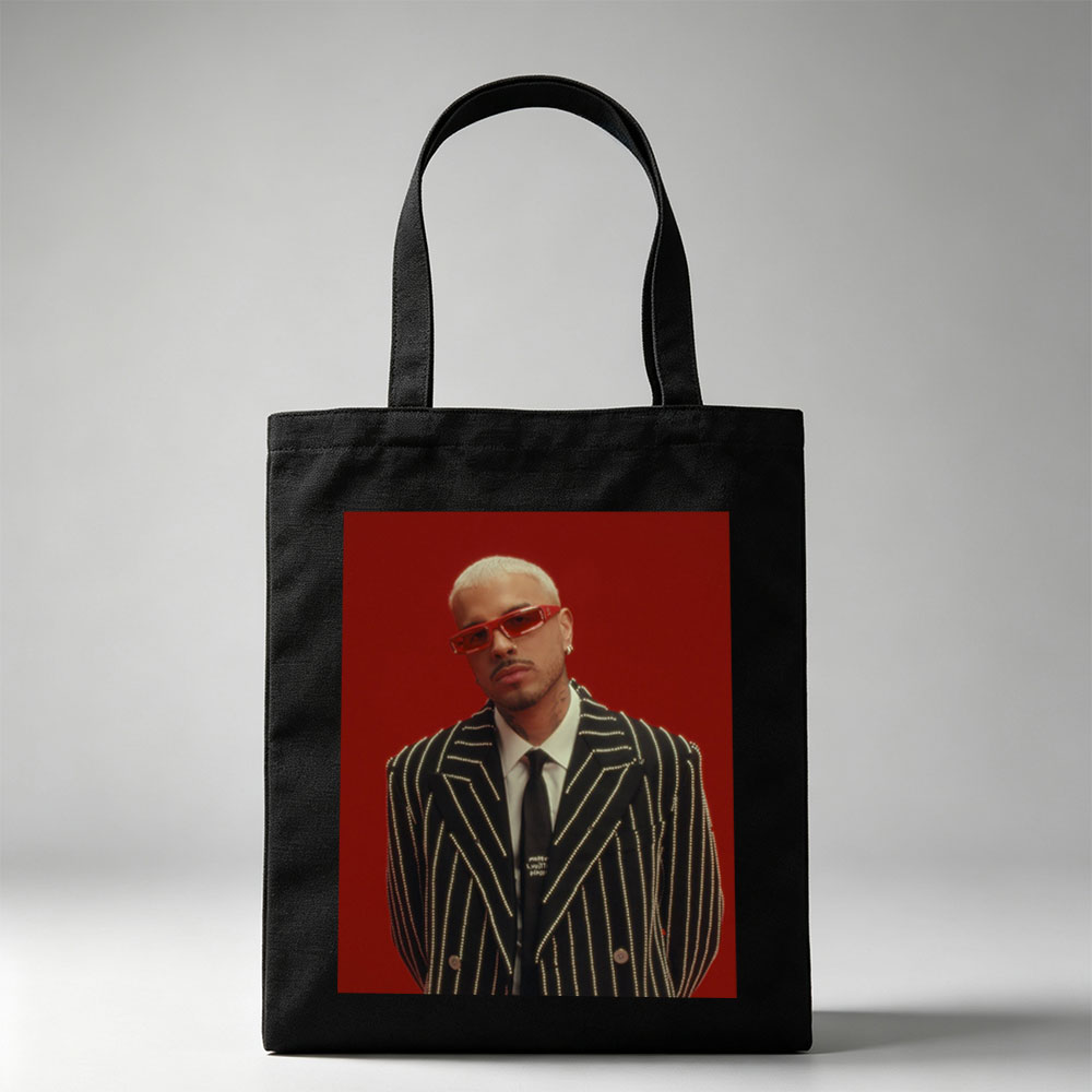 J Balvin in a Striking Red-Background Portrait Wearing a Glittering Black Suit and Red Sunglasses - Canvas tote bags