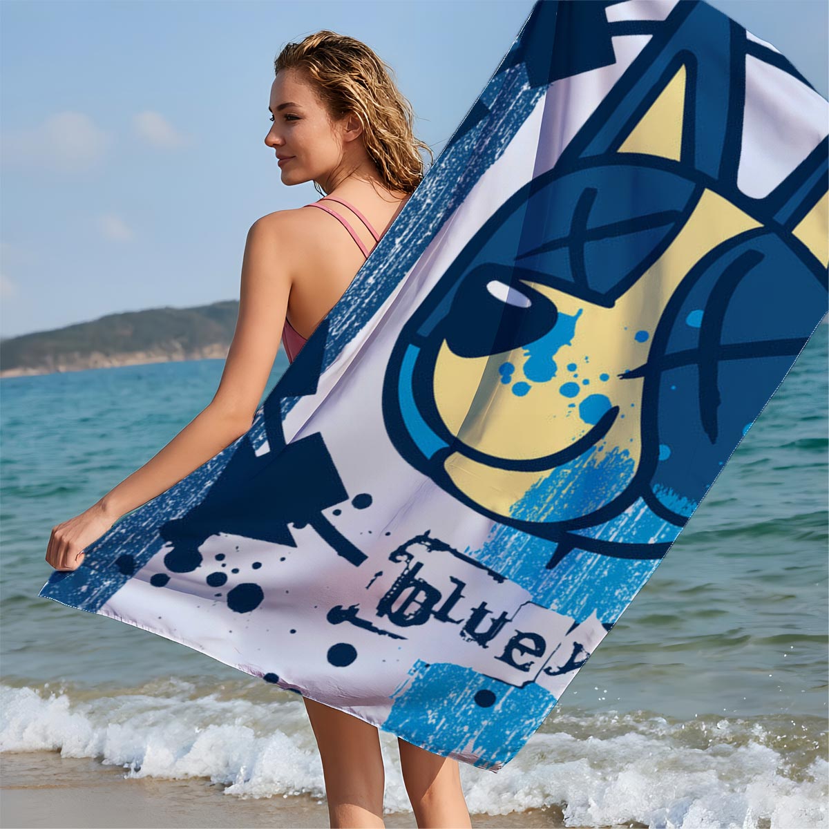 Bluey-182: A stylized blue and yellow cat face with X eyes, arrows, and splatter effects on a textured blue background. - Beach towels