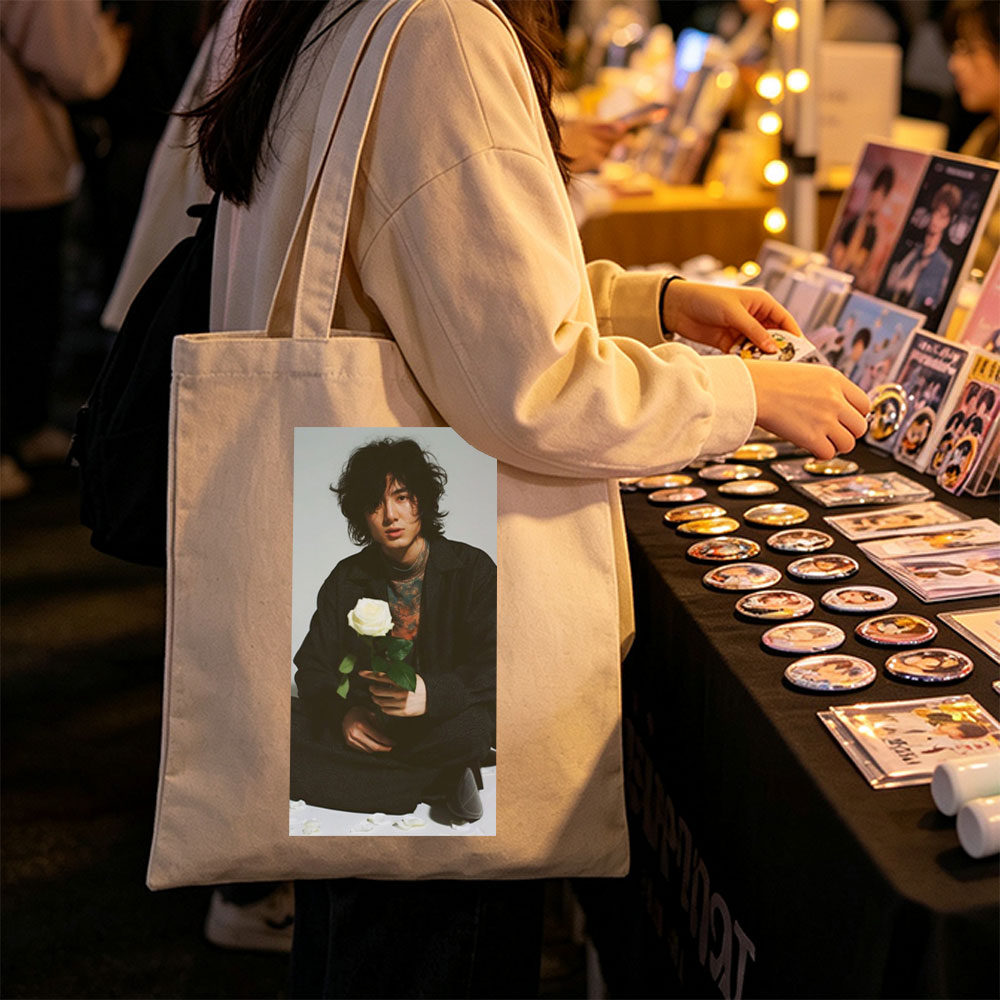 Yosuke Sugino Holding a White Rose in a Stylish Black Outfit with Petals Scattered Around - Canvas tote bags