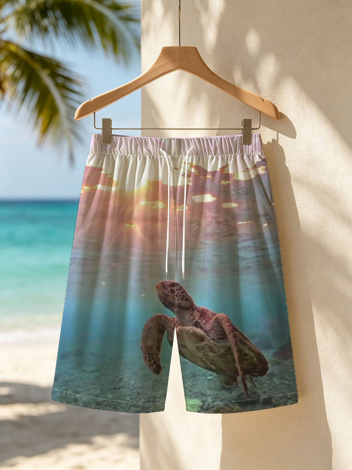 Sea turtle swims gracefully underwater as sunlight filters through the ocean surface. -  Beach shorts