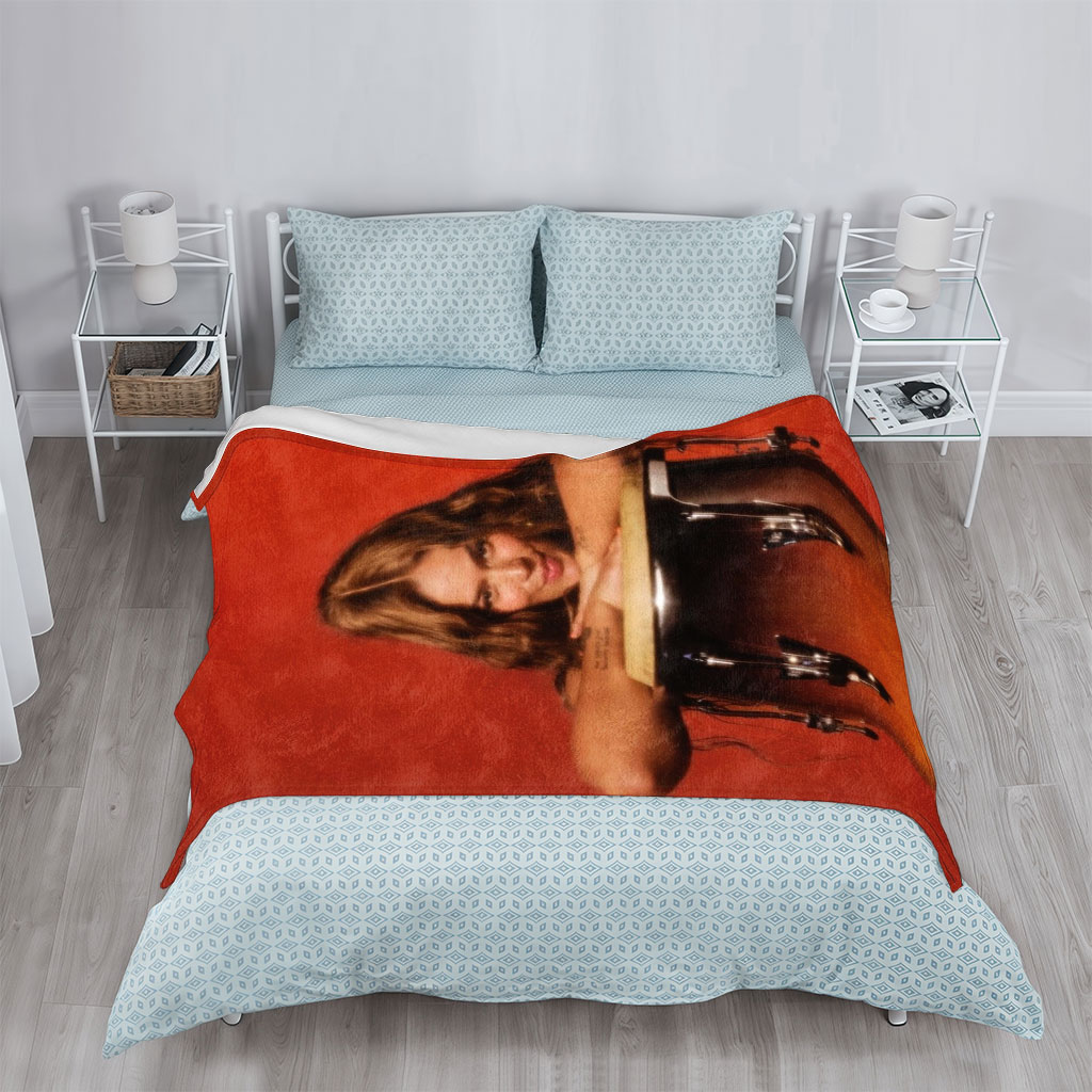 Maren Morris Leaning on a Conga Drum Against a Red Background - Blankets