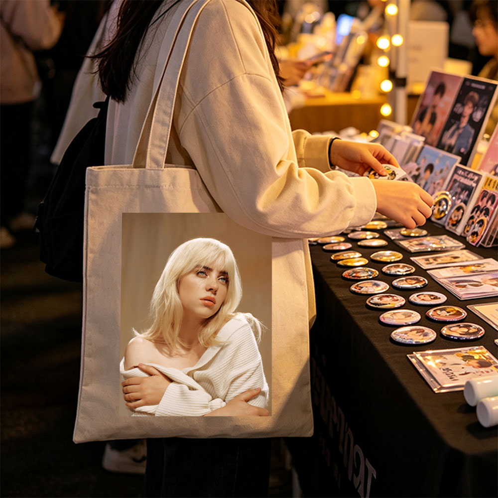 Billie Eilish in a Soft Portrait Wearing a White Off-Shoulder Sweater with Blonde Hair and Blue Eyes - Canvas tote bags