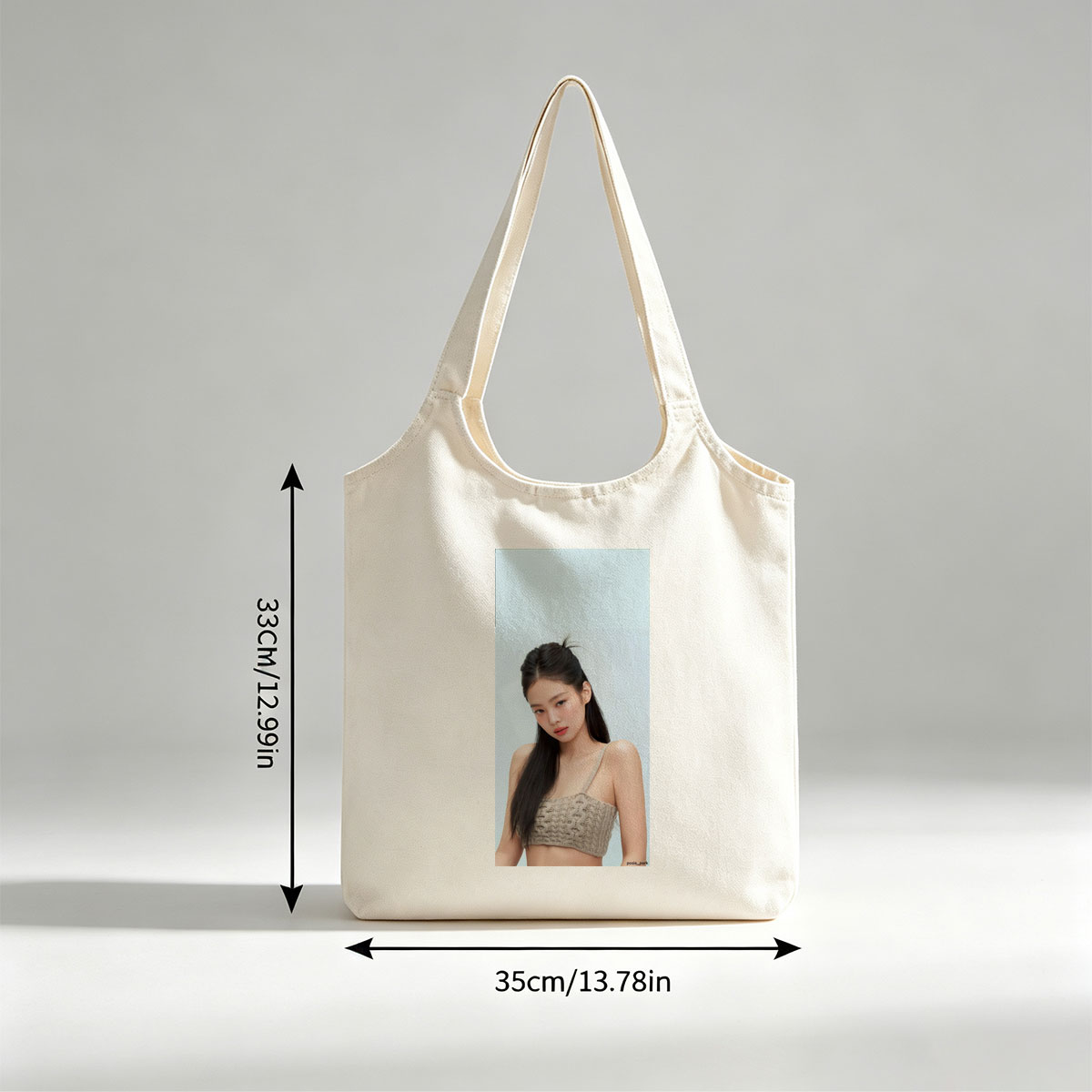Jennie Kim in a Minimalist Look Wearing a Beige Knit Crop Top Against a Soft Blue Background - Canvas shoulder bags/