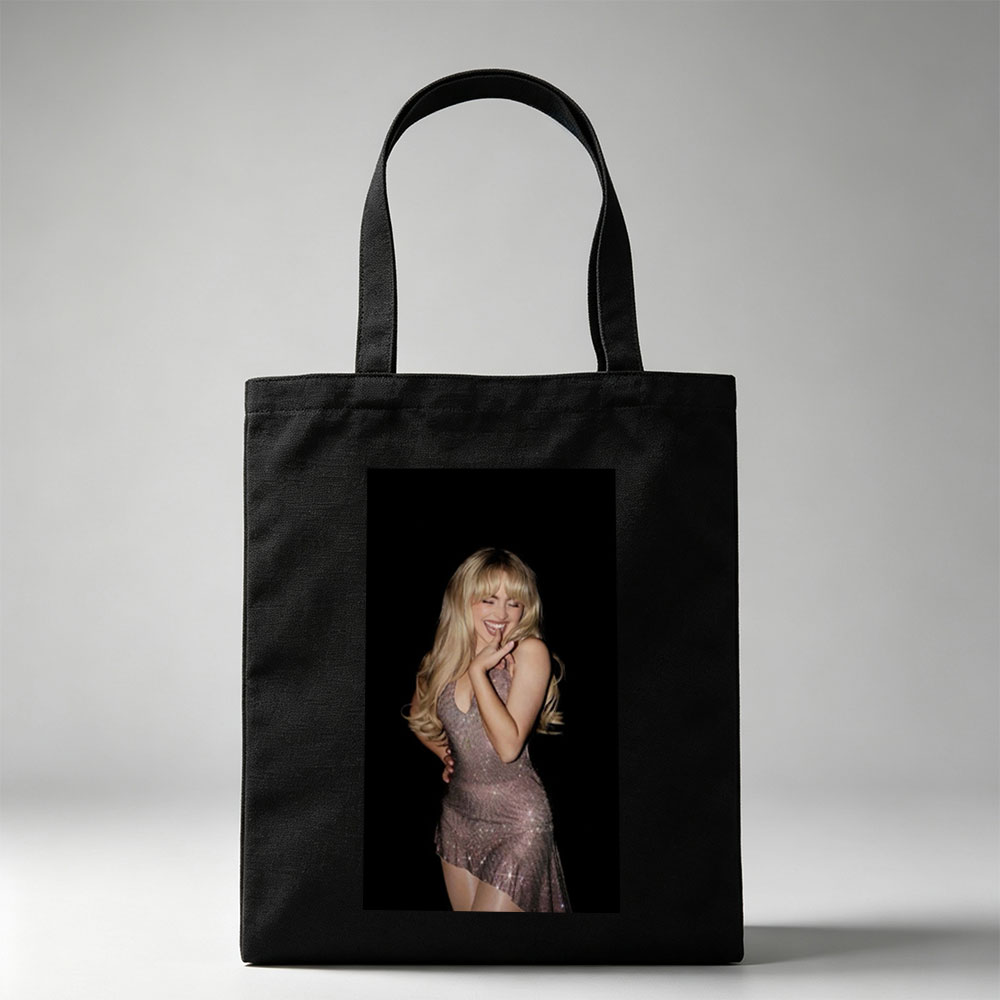 Sabrina Carpenter in a Sparkling Dress Posing with a Smile Against a Black Background - Canvas tote bags