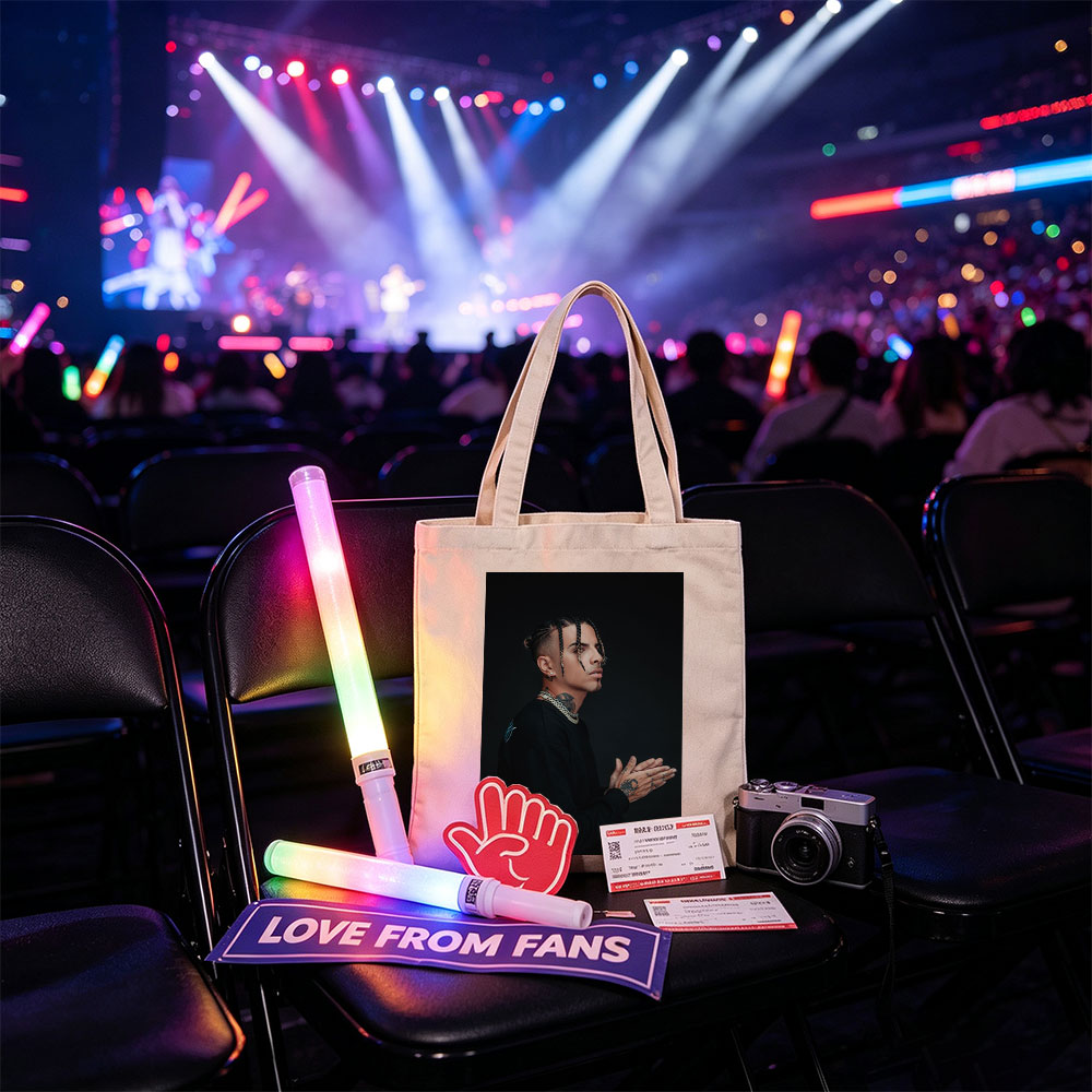 Daddy Yankee in a striking pose with braided hair and tattoos, wearing a black outfit and gold chain against a dark background. - Canvas tote bags