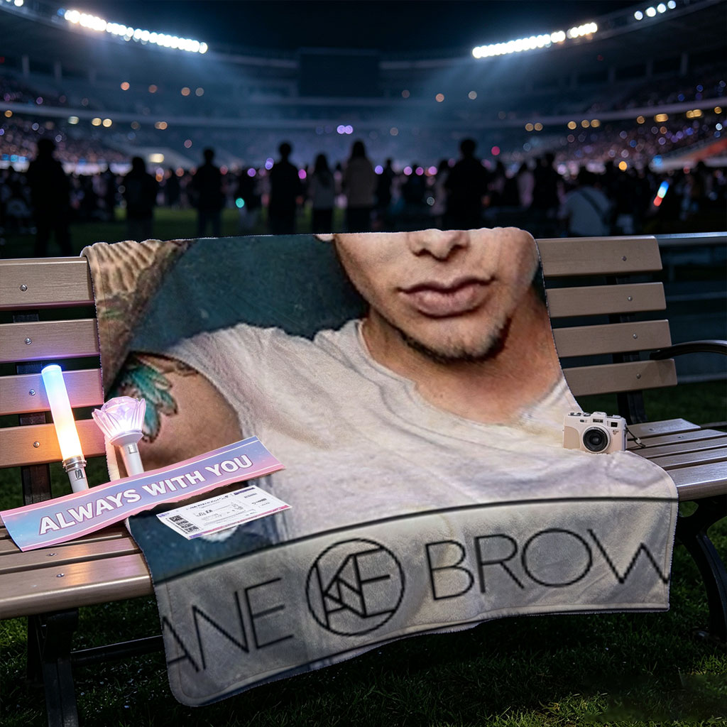 Kane Brown in a Casual Pose with Tattooed Arm and Cap on Dark Background - Blankets