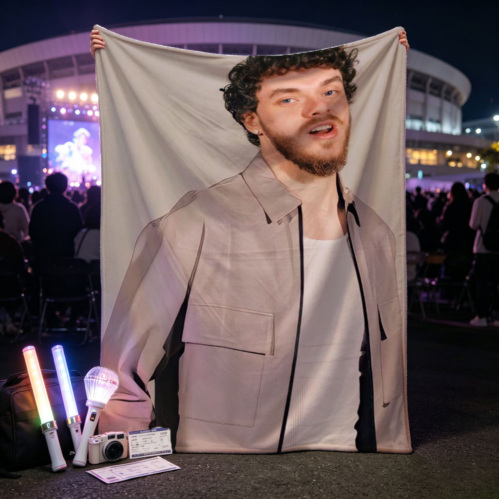 Jack Harlow in a Stylish Pose Wearing a Beige Jacket Over a White Shirt Against a Neutral Background - Blankets