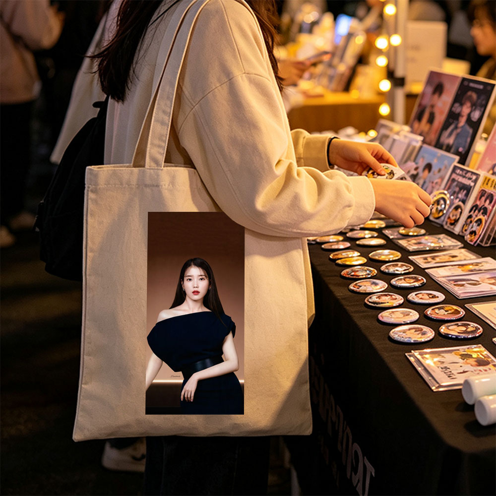 IU in Elegant Black Off-Shoulder Dress Against Warm Brown Background - Canvas tote bags