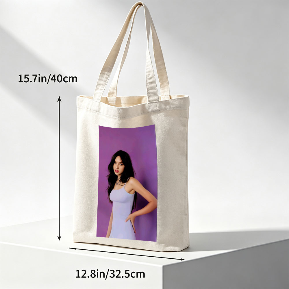 Olivia Rodrigo in a Light Blue Dress Posing Against Purple Background - Canvas tote bags