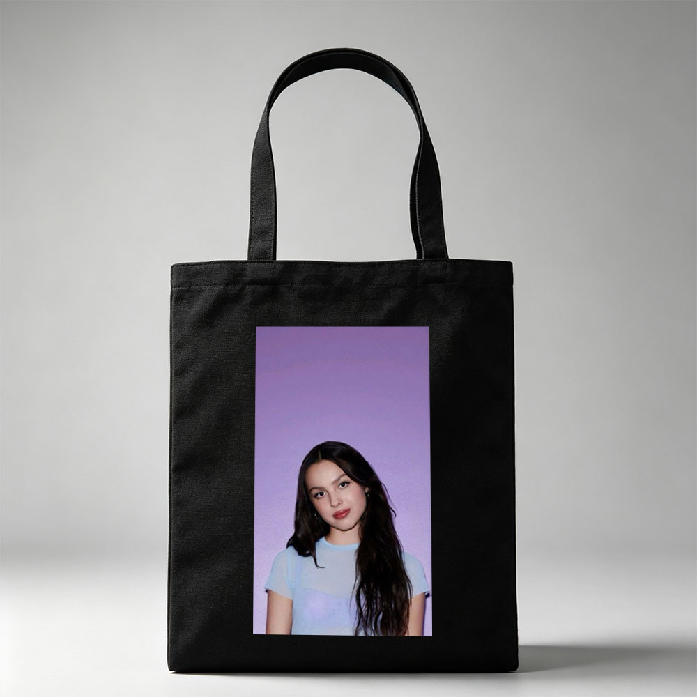 Olivia Rodrigo in a Soft Blue Top Against a Purple Gradient Background - Canvas tote bags