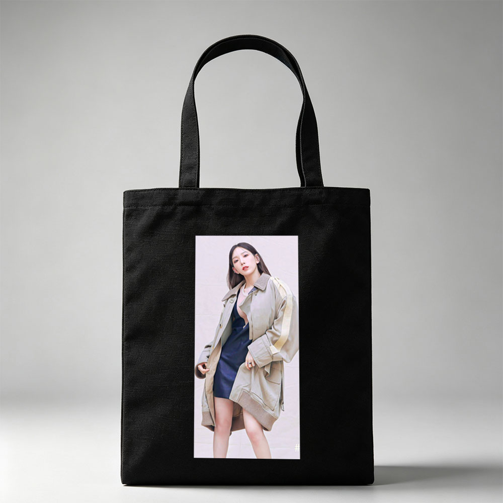 Kim Go Eun in a stylish urban look wearing a beige oversized coat over a navy blue dress, posing confidently against a neutral backdrop. - Canvas tote bags