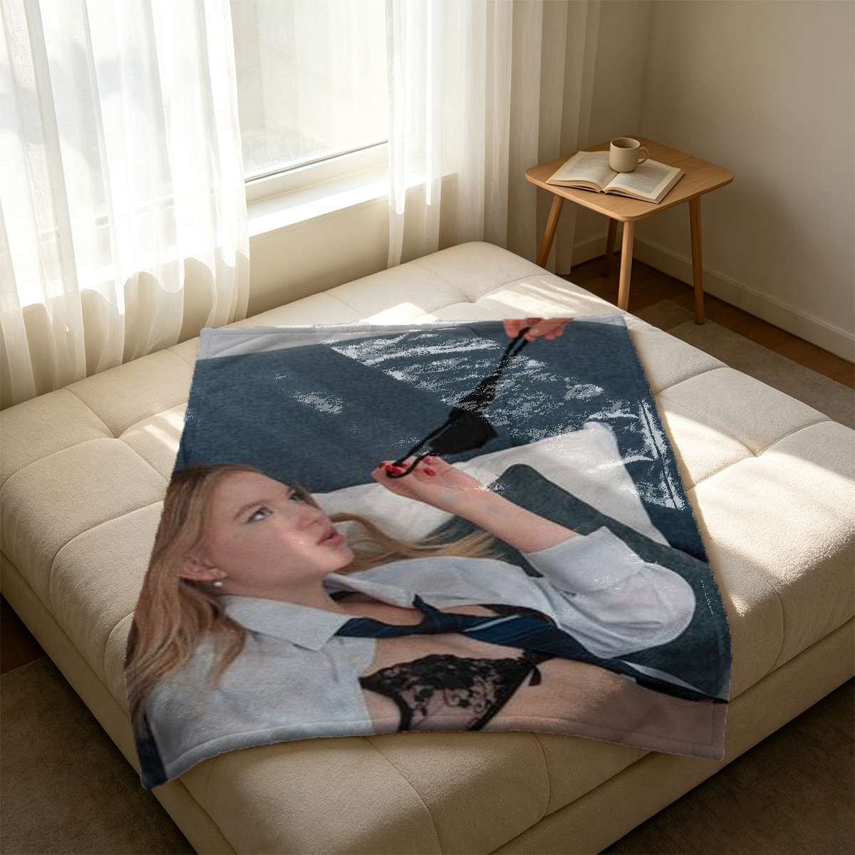 A young woman in a sheer black robe sits on a bed with an open suitcase of clothes in the foreground. - Blanket
