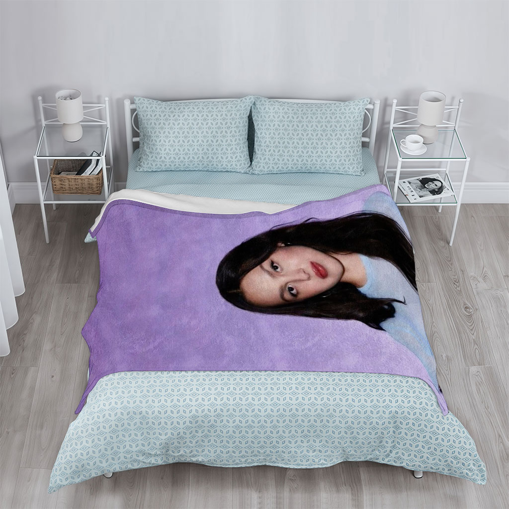 Olivia Rodrigo in a Soft Blue Top Against a Purple Gradient Background - Blankets