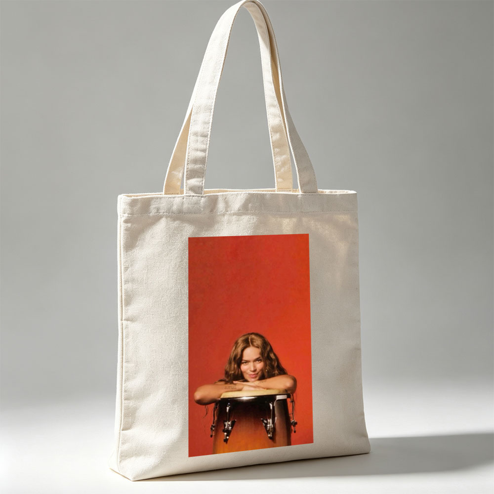 Rita Ora Leaning on a Drum Against a Red Background - Canvas tote bags