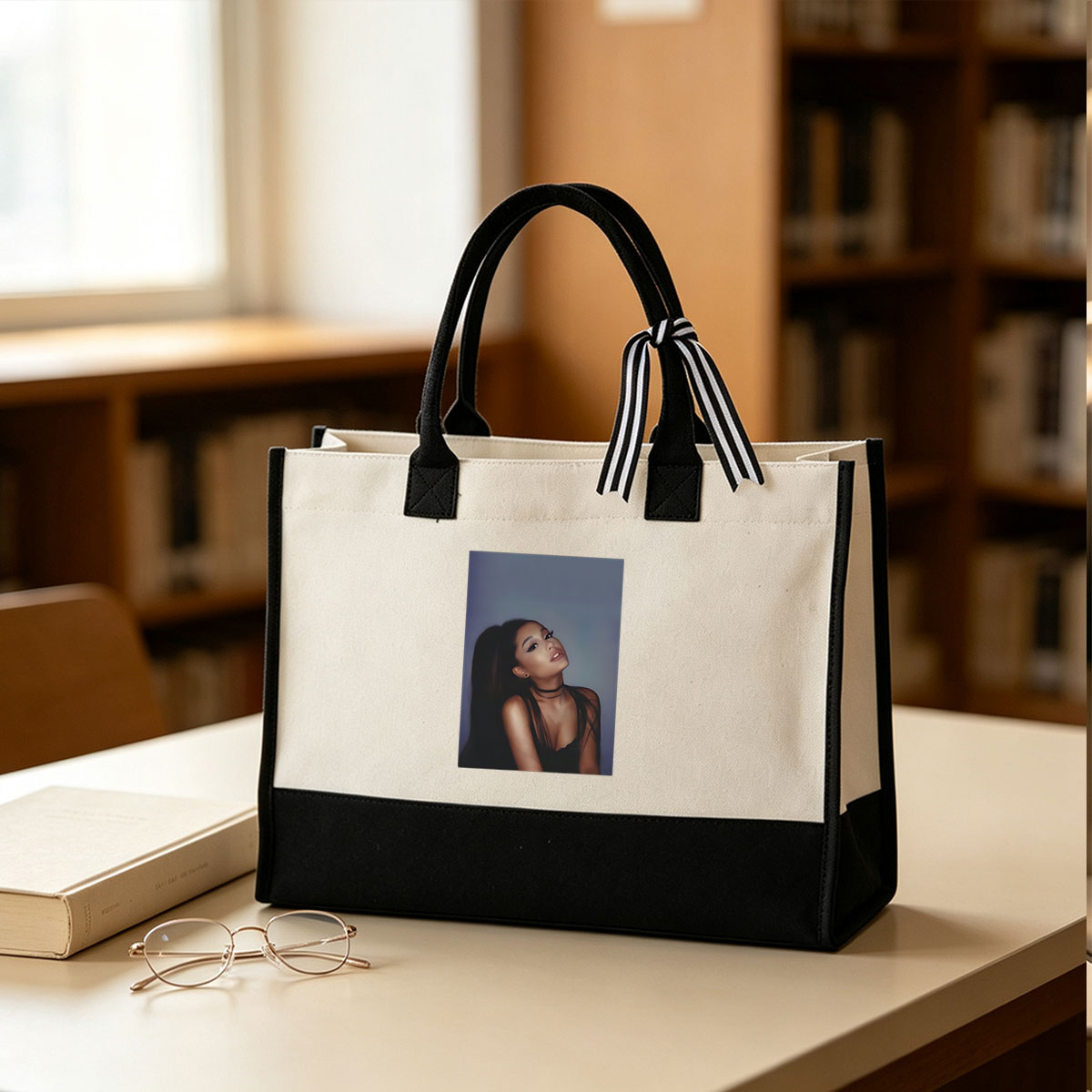 Ariana Grande in a stylish black outfit with a choker, posing against a soft blue background. - Canvas patchwork gift tote bag