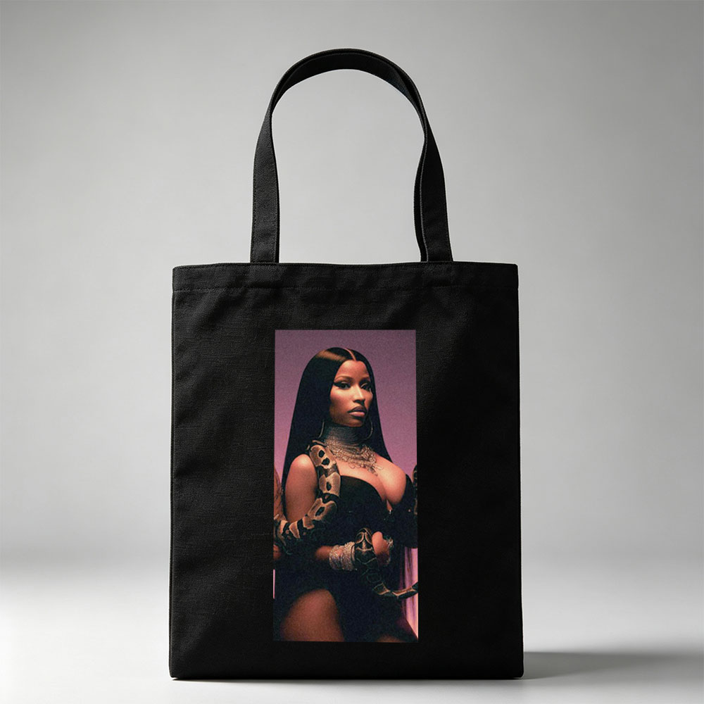 Nicki Minaj in a Dramatic Pose with a Snake Wrapped Around Her Arm and Neck, Wearing a Black Outfit and Heavy Jewelry - Canvas tote bags