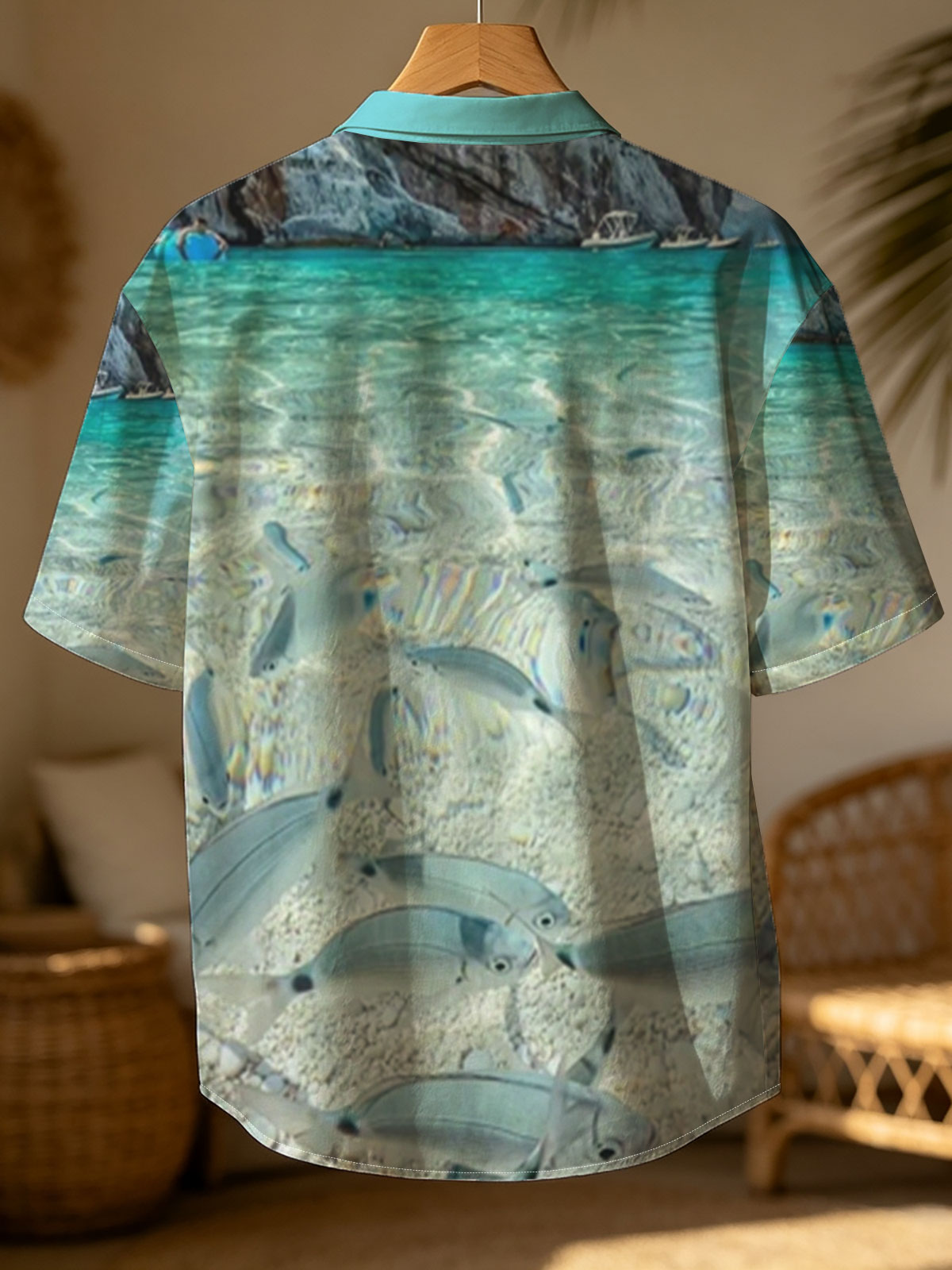 Clear waters reveal schools of fish swimming near a rocky shore with boats in the distance. -  Shirt