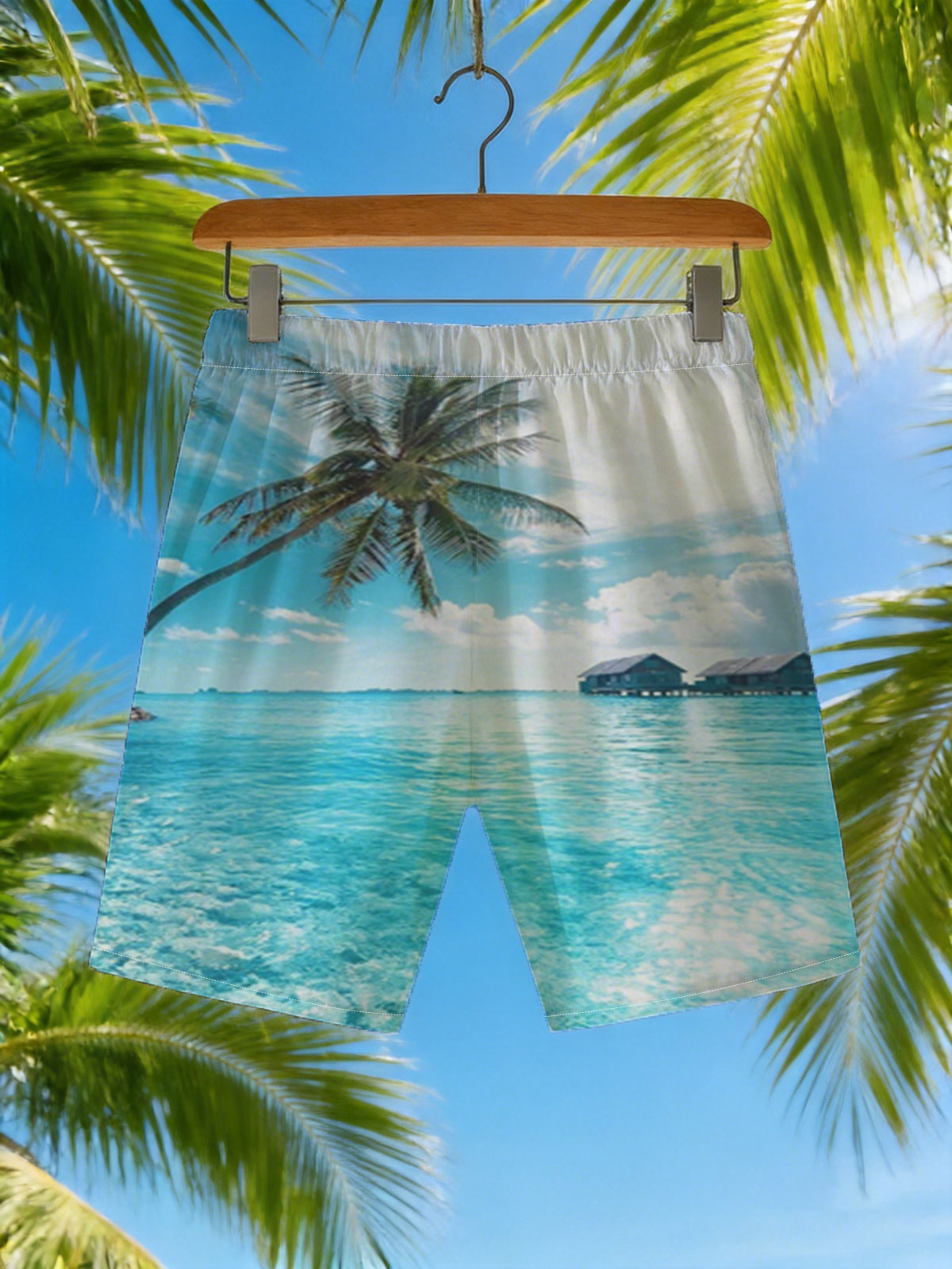 Tropical paradise with palm trees and overwater bungalows in crystal clear blue waters. -  Beach shorts
