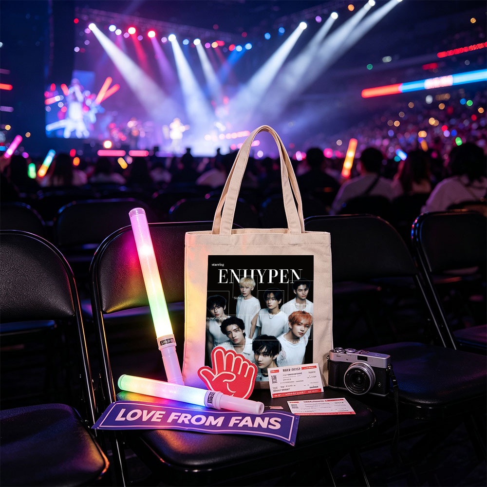 ENHYPEN in a striking black-and-white group portrait featuring all members in minimalist white outfits with individual name labels against a dark background - Canvas tote bags