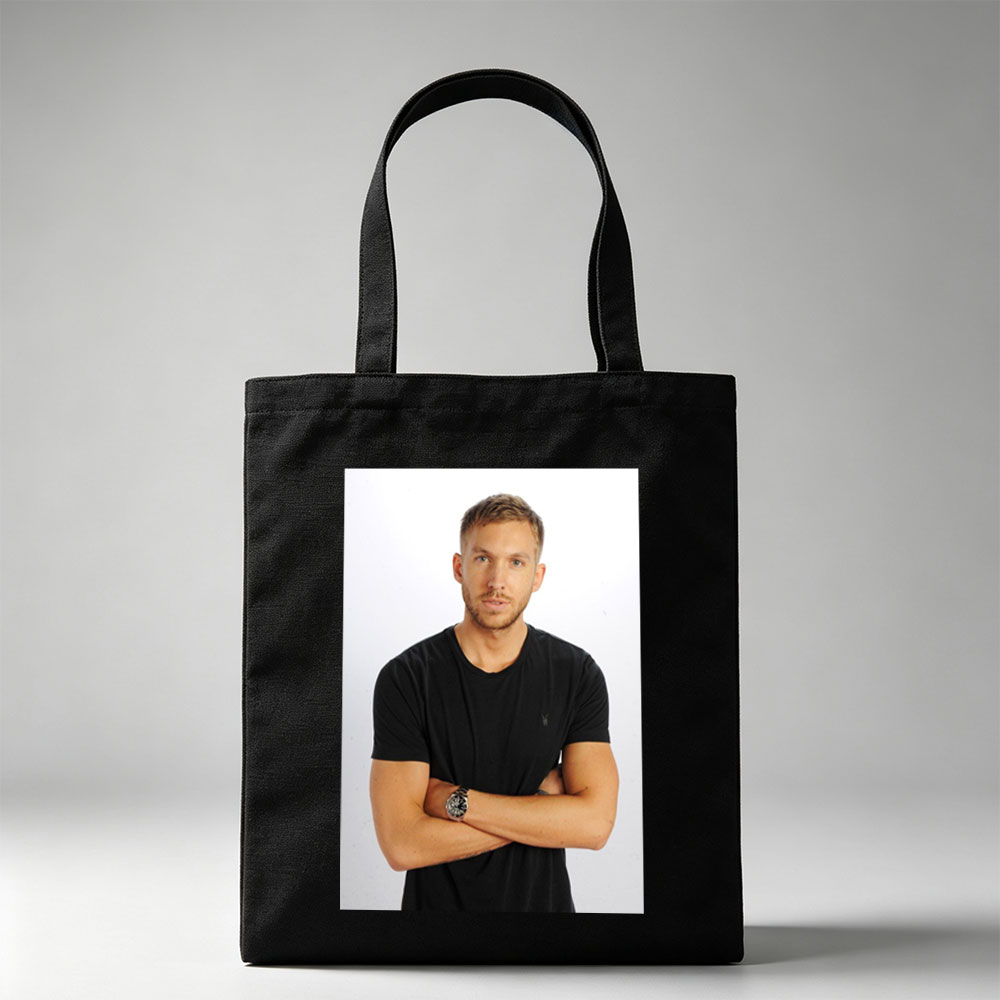 Calvin Harris Standing with Arms Crossed in Black T-Shirt Against White Background - Canvas tote bags