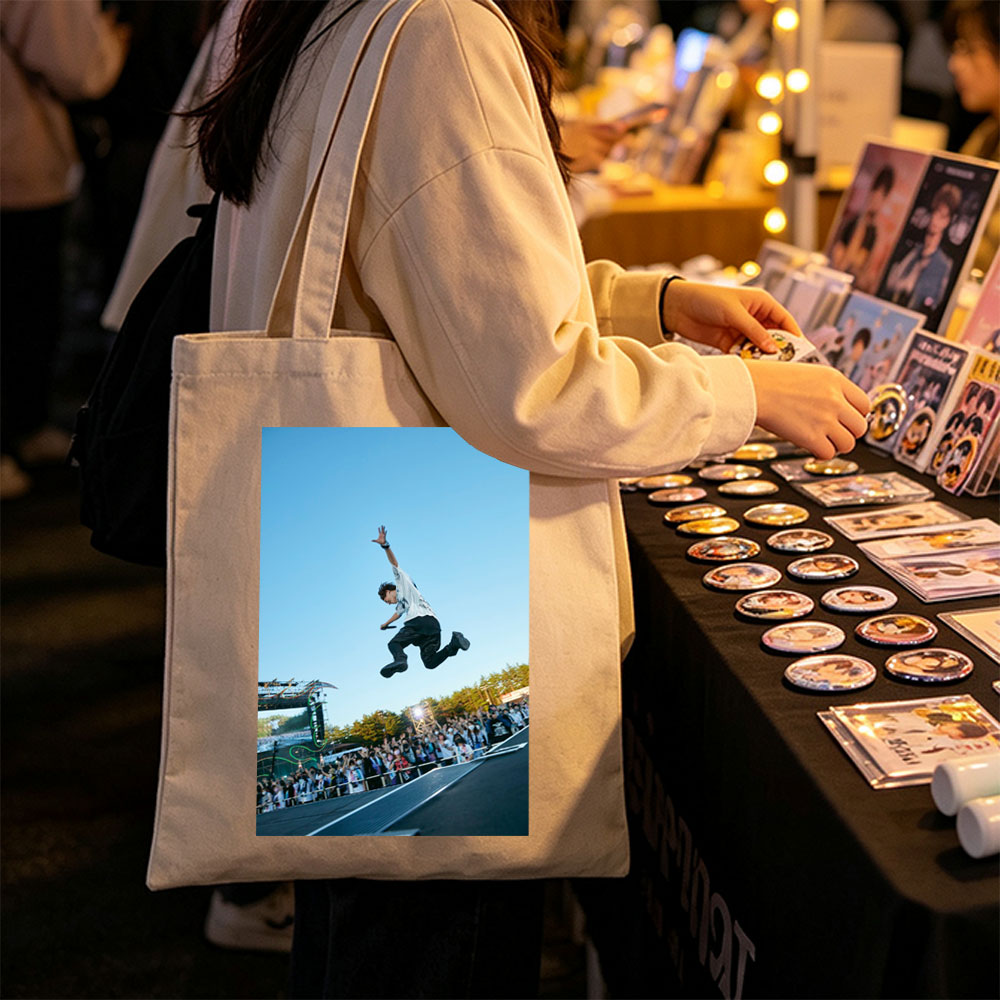 Skateboarder in Mid-Air Trick at Outdoor Festival with Crowd Watching - Canvas tote bags