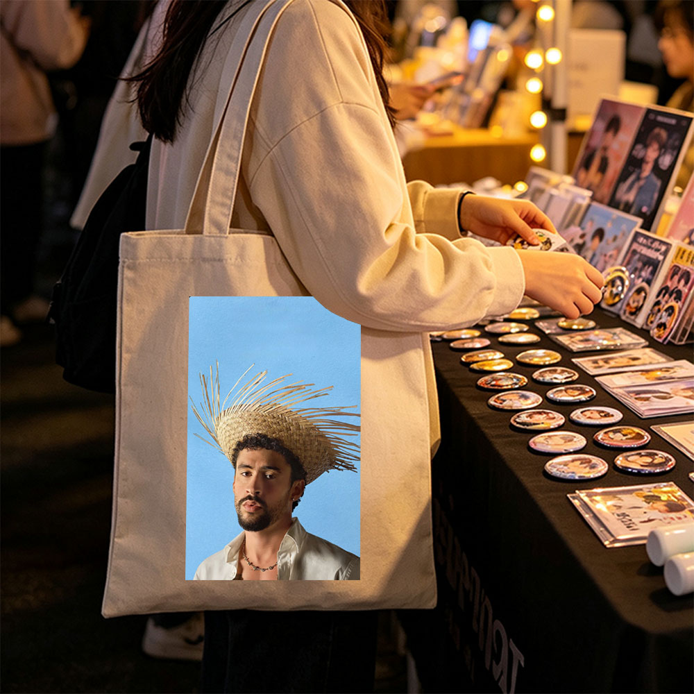 Bad Bunny Wearing a Straw Hat with Spiky Design Against a Blue Background - Canvas tote bags