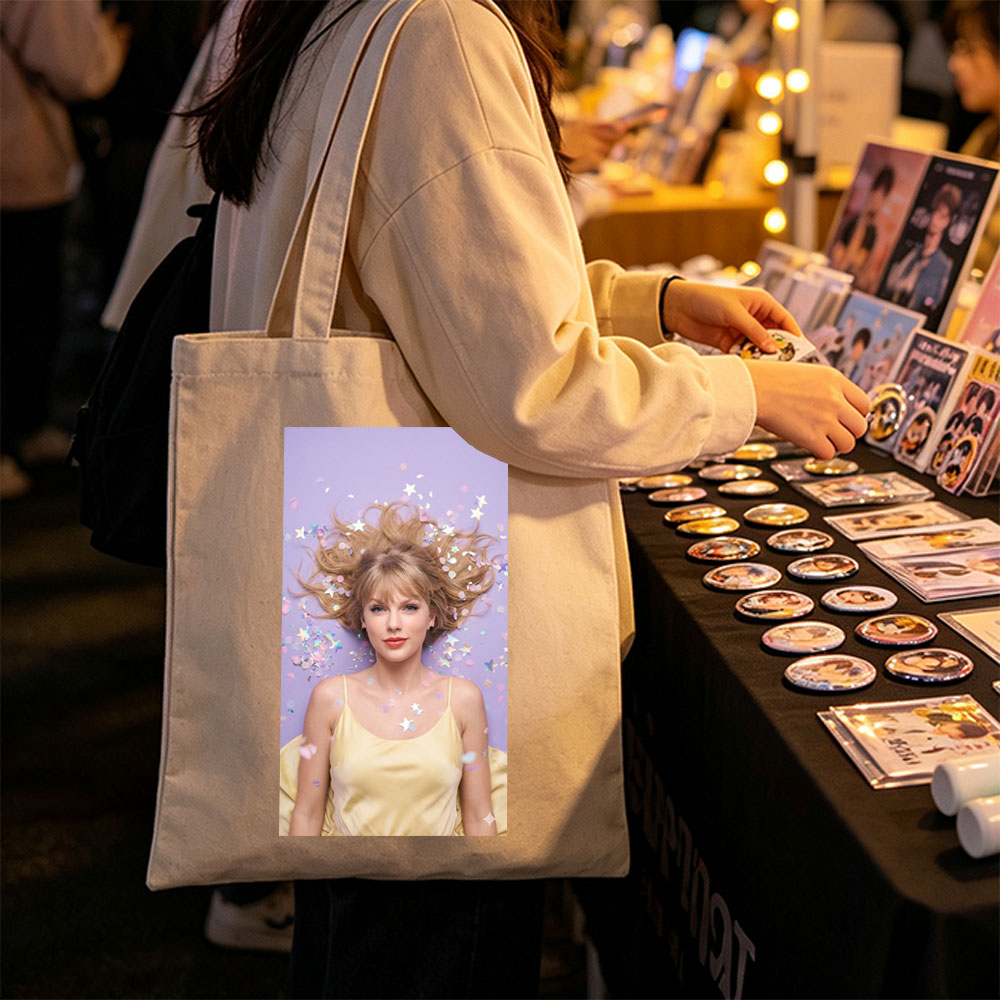 Taylor Swift Lying on Purple Background with Confetti and Stars Around Her Hair - Canvas tote bags