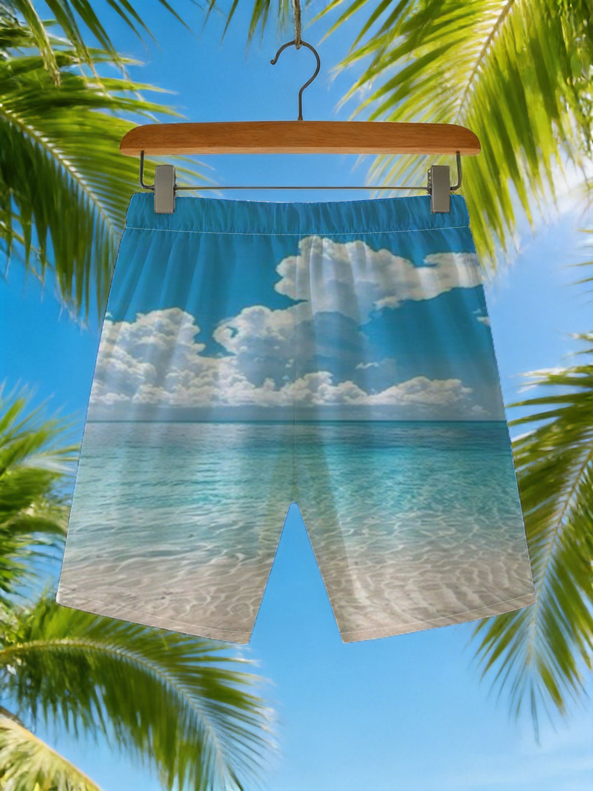 Crystal clear turquoise waters meet soft sandy beach under a vibrant blue sky with fluffy white clouds. -  Beach shorts