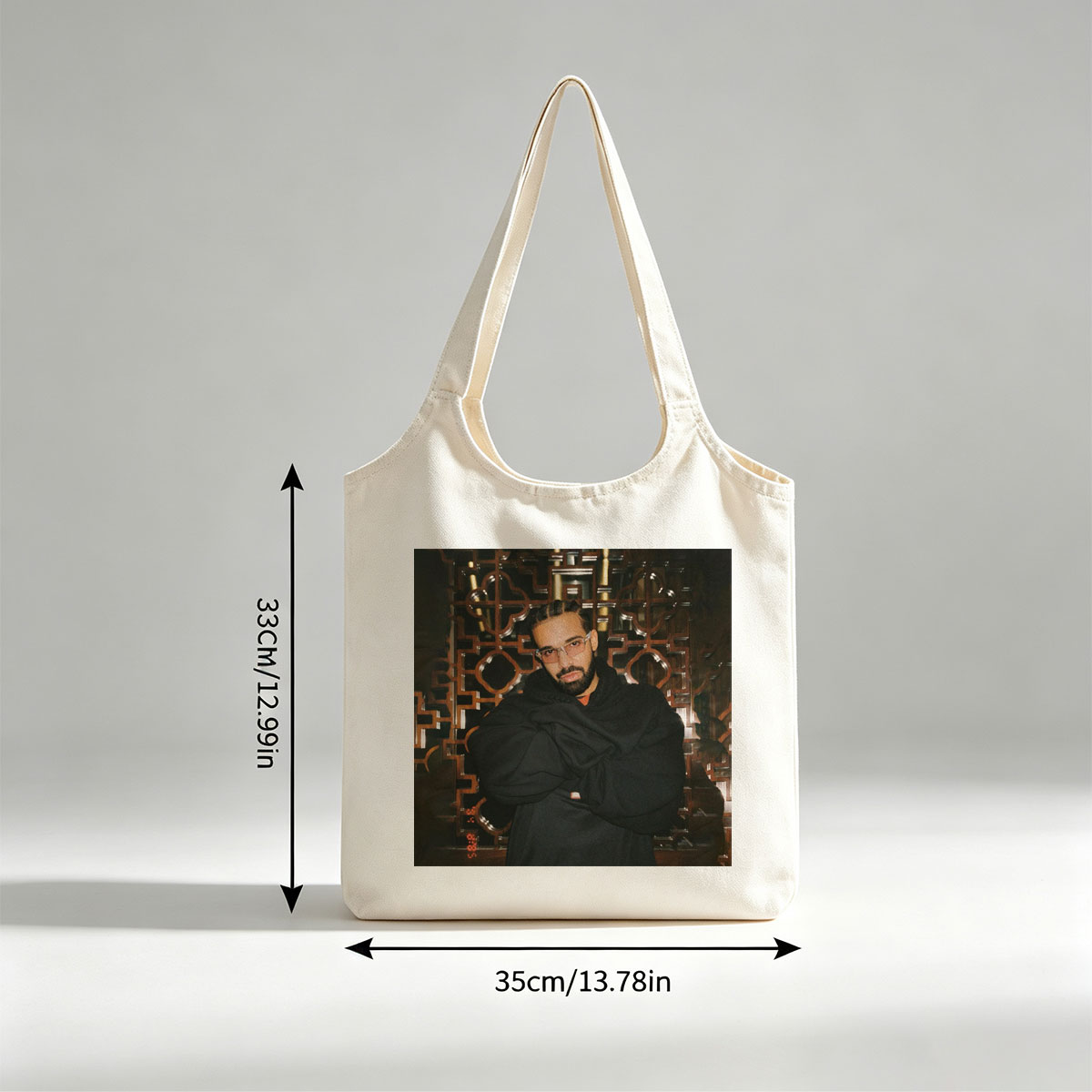 Drake in a Stylish Pose Against an Ornate Background Wearing Glasses and a Black Hoodie - Canvas shoulder bags/