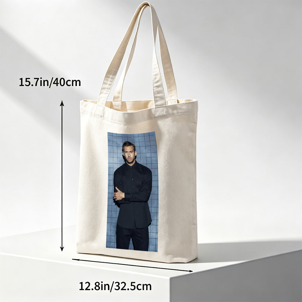 Calvin Harris in a Black Shirt and Pants Standing Against a Blue Tiled Wall with Arms Crossed - Canvas tote bags