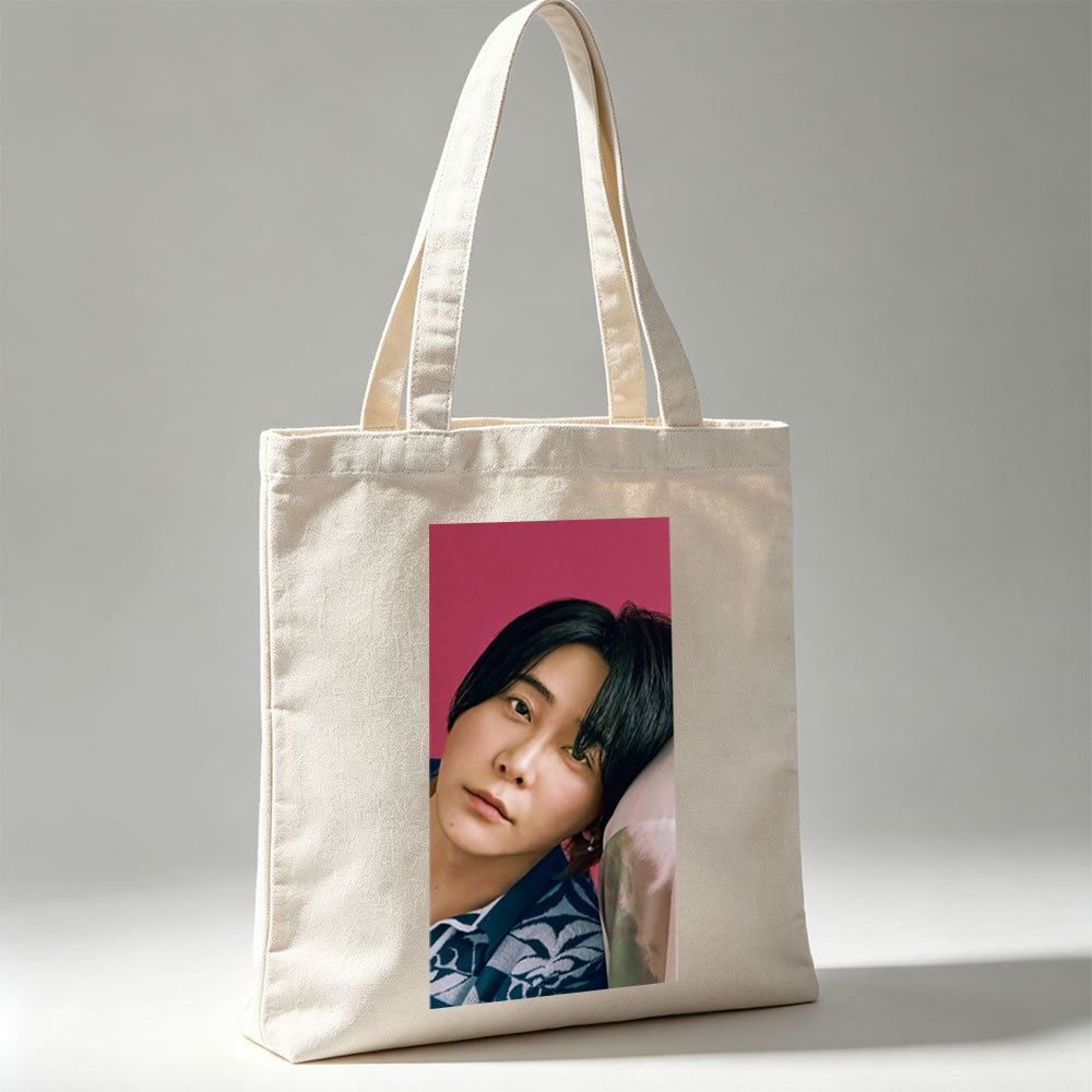 Yoshiki Hayashi in a Serene Pose Against a Vibrant Pink Background Wearing a Traditional Patterned Outfit - Canvas tote bags